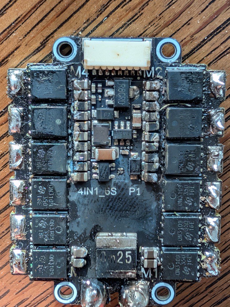 Burnt TBS Lucid ESC showing shorted center components caused by bent Gorilla aluminum bracket